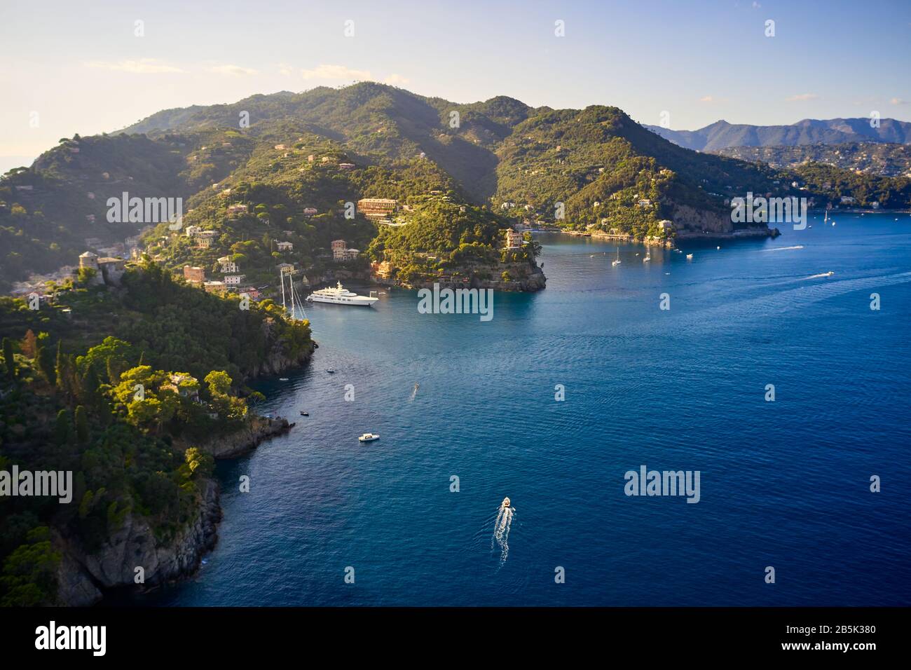 yachts-and-boats-are-sailing-in-the-ligurian-sea-on-the-mountain-background-portofino-italy-rocks-and-hills-seaside-with-the-traditional-italian-2B5K380.jpg